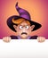 Mad wizard boy holding blank message card, Halloween banner illustration