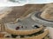 Madaba, Jordan, March 10, 2018: Parking lot with three cars and a simple kiosk on the King Highway just behind the Wadi Mujib Rese