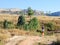 Madagascar, Isalo National Park, landscape with woman with laundry basket