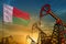 Madagascar oil industry concept. Industrial illustration - Madagascar flag and oil wells against the blue and yellow sunset sky