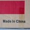 Made in China label on a shipment cardboard box with a red rectangle and tape.  It`s used and has background copy space
