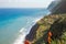 Madeira Island coastline with cliffs, village and blue ocean