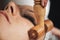 Maderotherapy Face Massage. Massaging Woman`s Face with Wooden Double Roller Massager