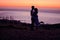 Madly in love. Full length shot of an affectionate young couple silhouetted at sunset.