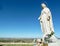 Madonna at the castle of Penas de San Pedro overlooking wind turbines in Castilla La Mancha, Spain.