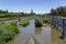 Madrid Rio Park. Views of the Madrid RÃ­o park next to the Manzanares river and green vegetation around it. Roads with bridges