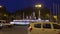 Madrid, Spain - December, 2019: Cars moving by the statue of Fountain of Neptune Fuente de Neptuno at night. This monument is
