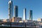 MADRID, SPAIN - FEBRUARY 02, 2019: Contrast between the four towers of Madrid`s financial district, the surrounding residential