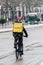 Madrid  Spain - January 2021: Glovo rider in Alacala street with hevy snow due to Filomena Storm. Rider on