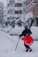 Madrid  Spain - January 2021: a person with skis and a sled in a street in the capital of Spain with heavy snow due to Filomena