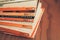 Madrid, Spain, May 10 2021: Stack of old vintage Penguin books on wooden shelf.