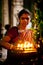 MADURAI, INDIA - FEBRUARY 16: Indian woman in colorful sari prays inside Meenakshi Temple on February 16, 2012. Meenakshi Temple