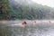 Mae hong son, Thailand - Dec 24 2016 : Tourist group wood rafting on fog reservoir in morning