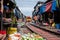 Maeklong Railway Market as Train is passing by