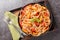 Mafaldine also known as reginette or simply mafalda or mafalde pasta in Creamy Tomato Sauce with capers and baked papper closeup