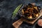 Mafaldine pasta with mussels and tomato sauce. Black background. Top view. Copy space