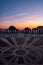 Mafra PORTUGAL - May 26, 2022 - Portuguese cobblestone effect in front of the National Palace with colorful sunset on the horizon