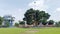 Magelang City, Indonesia - November 2022 : Large banyan tree and Water Toren heritage water tower in Park Of Magelang