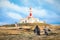 The Magellanic penguins with the Lighthouse of Magdalena Island background