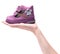 Magenta children`s boot on female hand