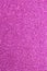 Magenta glitter background in reflective and shimmering material