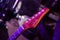 Magenta guitar fretboard in purple concert light