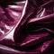 Magenta leather pieces the surface catching the light and highlighting its glossy texture. Trendy color of 2023 Viva