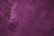 Magenta winter background. Surface of ice crystals close-up. Dark purple tinted grainy backdrop. An abstract Christmas pattern of