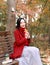 Magic autumn,Fall woman happy and bliss , Beautiful woman Sitting on a bench in autumn park