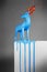Magic blue deer melting on a white pedestal