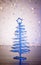 A magic blue metallic modern christmas tree on wood table