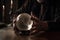 magic crystal ball being used for divination, with person seeking answers from the future