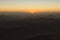 Magic golden sunrise in the mountains. The sun comes out from the cloud. View from Mount Sinai Mount Horeb, Gabal Musa