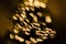 Magic holidays christmas defocused gold bright lights, bubbles and glitters in shape of christmas tree bokeh soft blur background