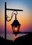 The magic light of the rising sun through the glass of a decorative lantern. Morning seascape