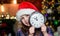 Magic moment is coming. Girl santa claus hat and clock. Meet Christmas holiday. Festive atmosphere christmas day. New