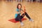 Magic pilates ring woman aerobics sport gym exercises on the floor, smiling and looking to camera.