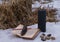 Magic ritual with black candle, runes on stones and open with book with spells on snow