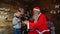 Magic Santa gives small boy for Christmas coveted gift in cozy room with big tree