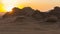 Magic sunset in Mountains of Wadi Rum Desert, Jordan. Red-brown mountains in last rays of  setting sun