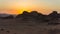Magic sunset in Mountains of Wadi Rum Desert, Jordan. Red-brown mountains in last rays of  setting sun