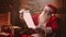 In a magical atmosphere Santa Claus reads a paper scroll with a list of children for gifts