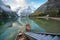 Magical autumn landscape with boats on the lake near snowy stair