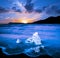 Magical charming beautiful landscape with a piece of ice like a sculpture on the Diamond beach near glacier lagoon Jokulsarlon,