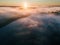 A magical dawn. Autumn fog covers fields and lakes. Long shadows from the trees. Photo from the drone.