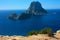 The magical island of Es Vedra with the small islet of Es Vedranell next to it in front of the coast of Cala d`Hort in the touris