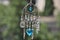 Magical and miraculous. Luck amulet hung out outdoor. Silver amulet with gems and pendants. Believing in magic protecting the