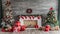 Magical nostalgic retro Christmas presents, sweets and anniversary cakes in front of a festive backdrop with colorful decorations