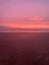 Magical pink sunset over the enchanted beach in a vertical view