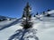 A magical play of sunlight and shadow during the alpine winter on the snowy slopes above the mountine resort of Arosa